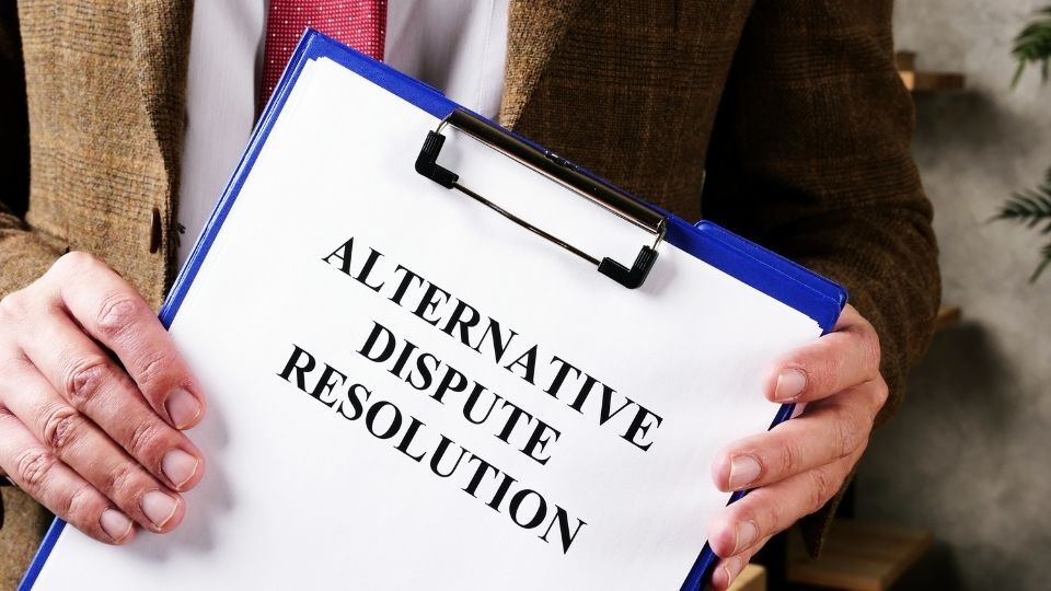 (In the image a person can be seen holding an alternative dispute resolution documents in his hands) How to Start the Alternative Dispute Resolution HMRC Process: A Step-by-Step Guide