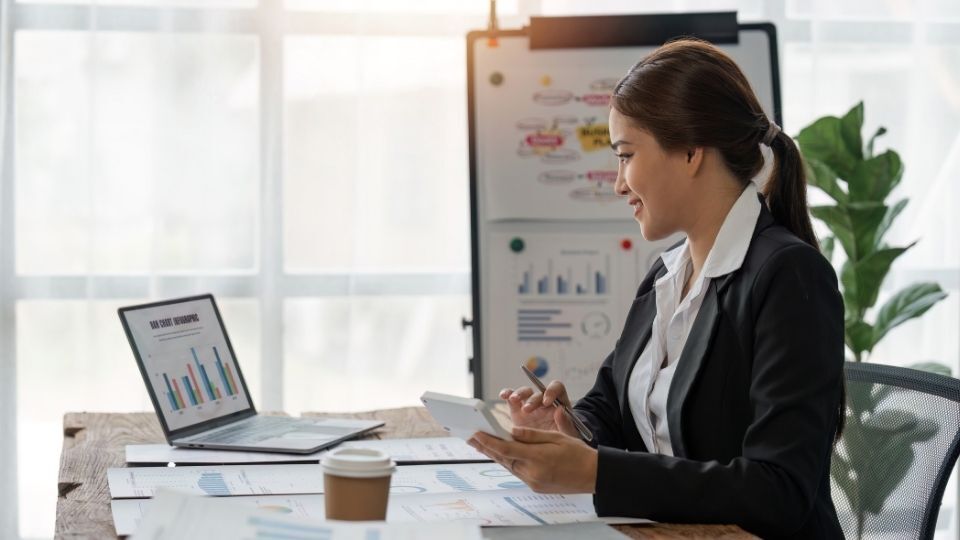 (A woman can be seen navigating through her small business tax and income by herself) 