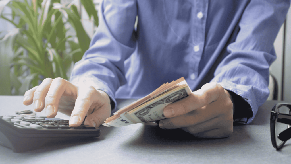 (This image represents a person calculating his due tax and preparing to pay it to avoid Tax Evasion Penalties) Tax Evasion Penalties