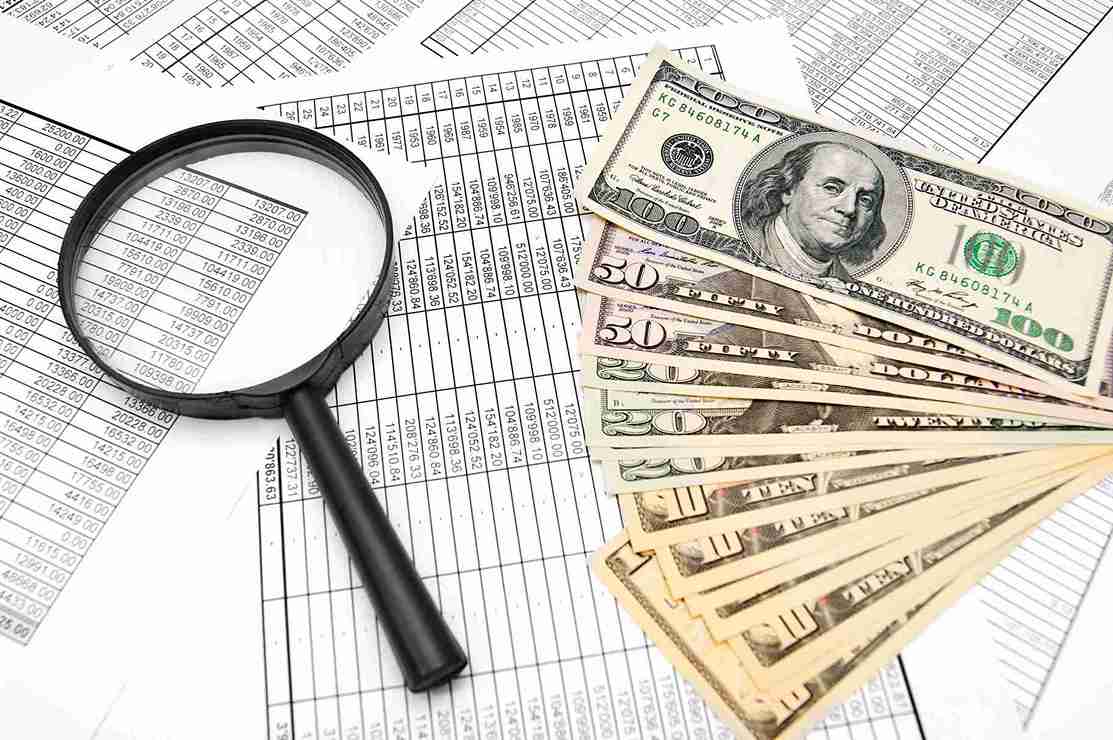 Image illustrating steps to secure a business loan, featuring charts, documents, and a calculator on a desk.