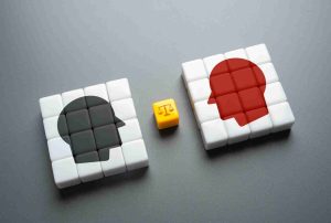 Two cubes displaying contrasting figures to represent Alternative Dispute Resolution HMRC and the balance between opposing tax dispute outcomes.