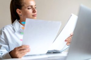 A professional reviewing documents, representing the careful record-keeping needed to avoid tax fraud.