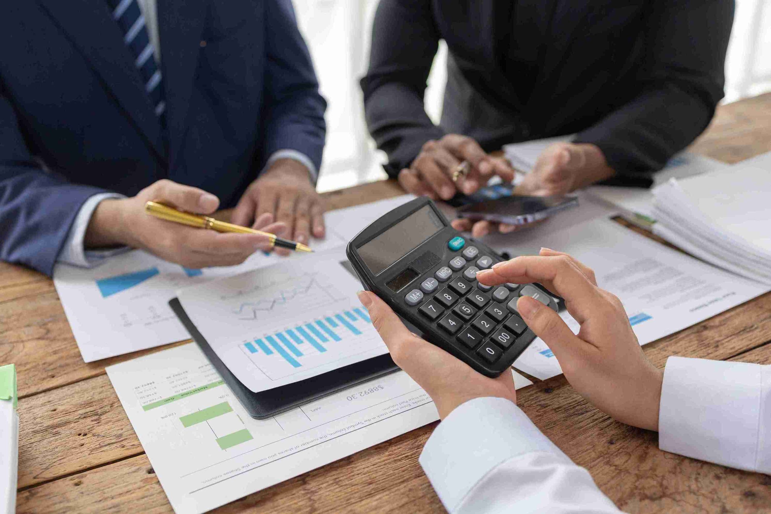 Businessman examining financial data closely with a magnifying glass, highlighting attention to detail in his analysis.
